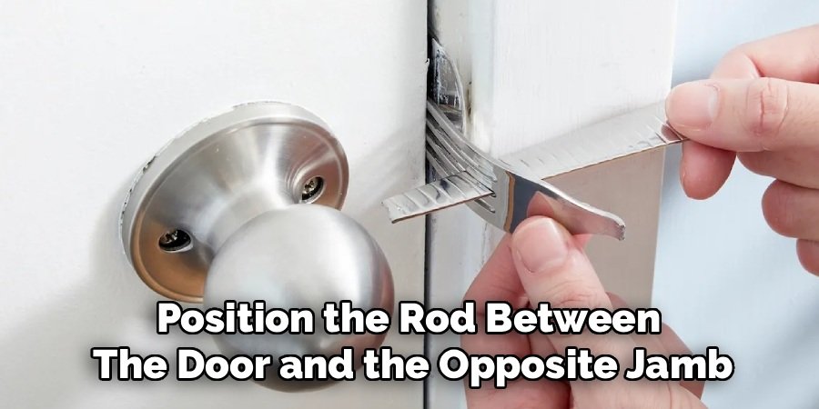 Position the Rod Between
The Door and the Opposite Jamb